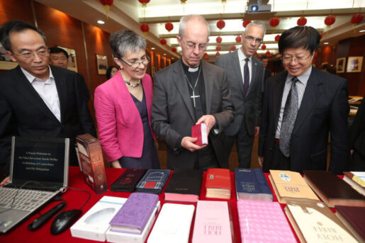 Justin Portal Welby Archbishop of Canterbury inspecting Amity Bibles during a visit