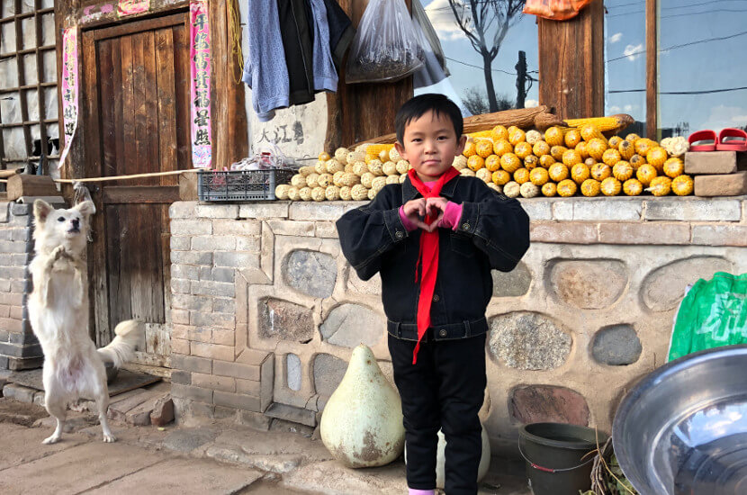 Sponsored by forming a heart with his hands in front of his rural home