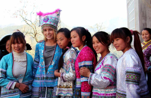 Amity volunteer from Norway taking photo with Chinese girls in traditional clothing