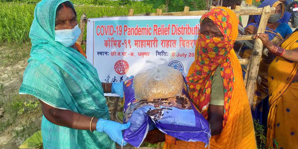 Nepalese women receive rice and food support during the Covid-19 pandemic