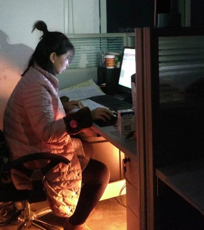 Yanfei is working on her desk late in the evening